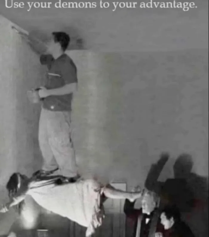 Man humorously using levitating woman to paint ceiling, embodying random memes that are unexpectedly funny.