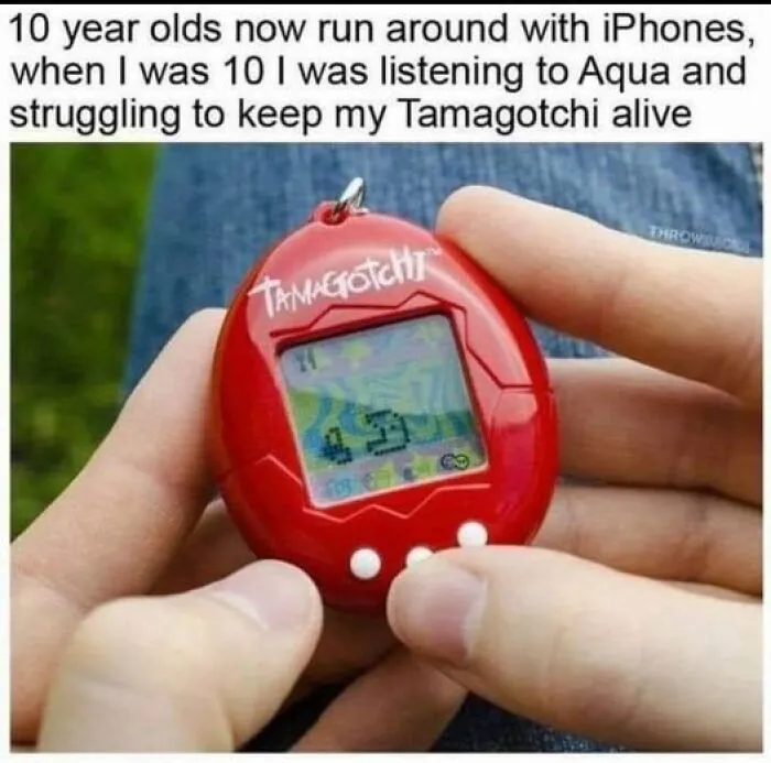 Person holding a red Tamagotchi, a popular '90s digital pet, with a nostalgic caption about childhood.