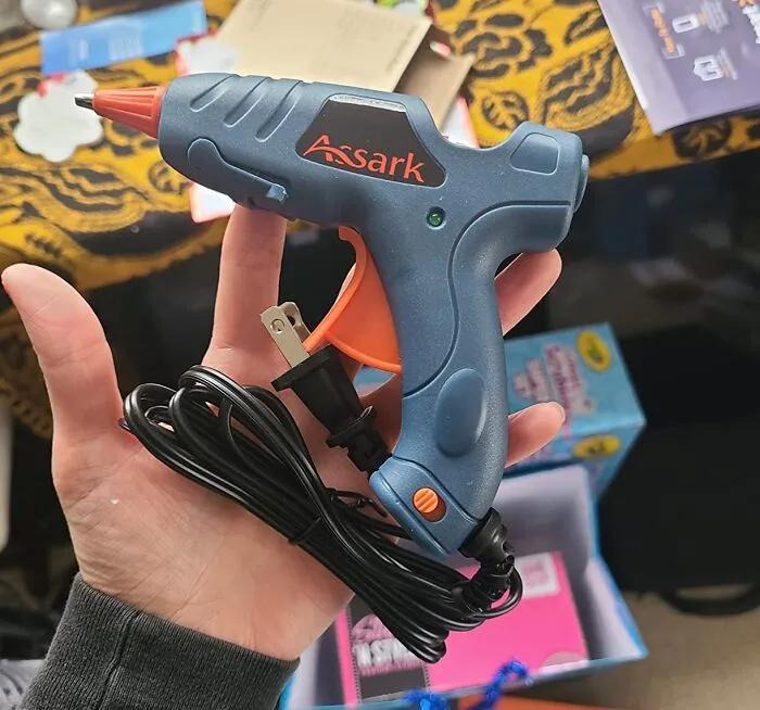 Keep those picture frames in place and prevent unsightly scratches on your walls by applying a few small dots of hot glue to the back corners of the frame using a   <a style="display:inline;" href="https://www.amazon.com/Assark-Sticks-School-Repairs-20W/dp/B09FYWQ44L?crid=3BH6U9RZKZ585&dib=eyJ2IjoiMSJ9.upjfxg1sTDCl9qTdelR1nQ1tTOYPNLLUXT12T2VAvDzBRwqkE8Zzz7scTBPgK4q5P2EEa79kI48OhBg7pfo7cRKbWY3ojjIPPlNyk6JxKSbjJII0_uXJrIANqoiXLDj58jYJ42cHYwdJ9zE8IkeWjF6Qh2Aa8MpdJRHB6mc0GqaRp3G_89Kwcj232kXvrBA3qb62wNX2bYKL0cGfDy7aQ3cOKBluQg6fcWxo5WNrIjN5SHpoOKf8c3nNzsmTqU5L5nKSXfUJVR-3BSPrgzgFf2WPB_ky6Xak9gRI44JDKTA.SEuB3_LntyuTidlIh3_JKSMCA13F_7egSrOCDlOlSdo&dib_tag=se&keywords=hot%2Bglue%2Bgun&qid=1723173506&sprefix=hot%2Bglue%2Caps%2C715&sr=8-3-spons&sp_csd=d2lkZ2V0TmFtZT1zcF9hdGY&th=1&linkCode=ll1&tag=bpyak-20&linkId=0b895f0bb10f68c06cb85b2a142127c9&language=en_US&ref_=as_li_ss_tl " target="_blank"><span style="font: inherit; color: #d74b1f;">hot glue gun</span>. The hot glue acts as a discreet bumper, creating a secure grip and keeping the frame slightly away from the wall. It's a quick and easy solution for a common household annoyance!