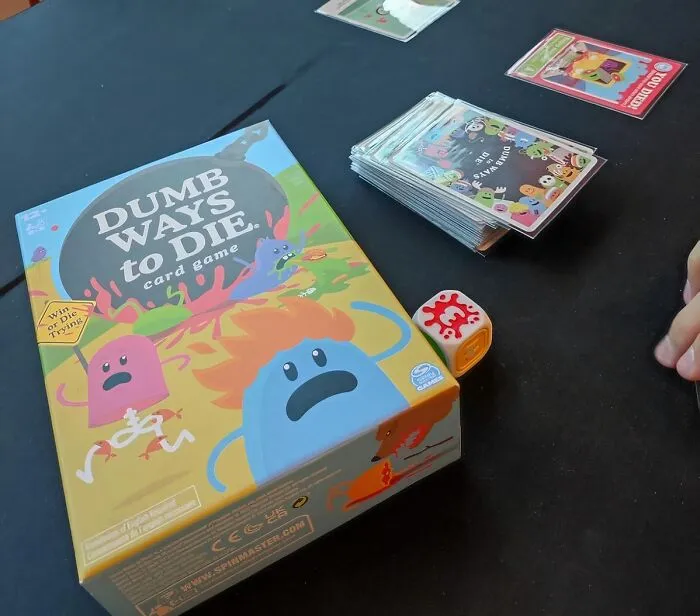 This Game Will Have You Dying (Of Laughter) At The Silliest Ways To Kick The Bucket. Don't Worry, It's All In Good Fun With <a Style="Display:inline;" Href=" Https://Www.amazon.com/Dumb-Ways-Die-Hilarious-Birthday/Dp/B0brt572wh?crid=1rmbnr85qb2xp&dib=eyj2ijoimsj9.i-Qd7a2-Cspkc_4zi0l4hknfttwc9ncjva_r3fmiex8kbov_t0gmtusjgibthjyw5jun7otvdbeip2luvixrja3pew1t4lathxuvqskeqvk.vynzivnkjrstebxzl1eznvtuepqghwo53ie_ld4ibis&dib_tag=se&keywords=don%27t+be+a+dik+dik+card+game&qid=1724051030&sprefix=don%27t+be+a+dik+dik+card+game%2caps%2c238&sr=8-5&linkcode=ll1&tag=bpparrot-20&linkid=014872bfdc33a703e79ff6c7e4fef081&language=en_us&ref_=as_li_ss_tl" Target="_blank">     <span Style="Font: Inherit; Color: #d74b1f;"> Spin Master Games' Dumb Ways To Die</Span>