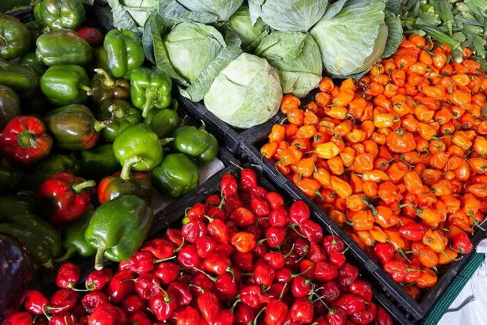 Fresh colorful vegetables including peppers and cabbage at a market stall, highlighting things people started appreciating with age