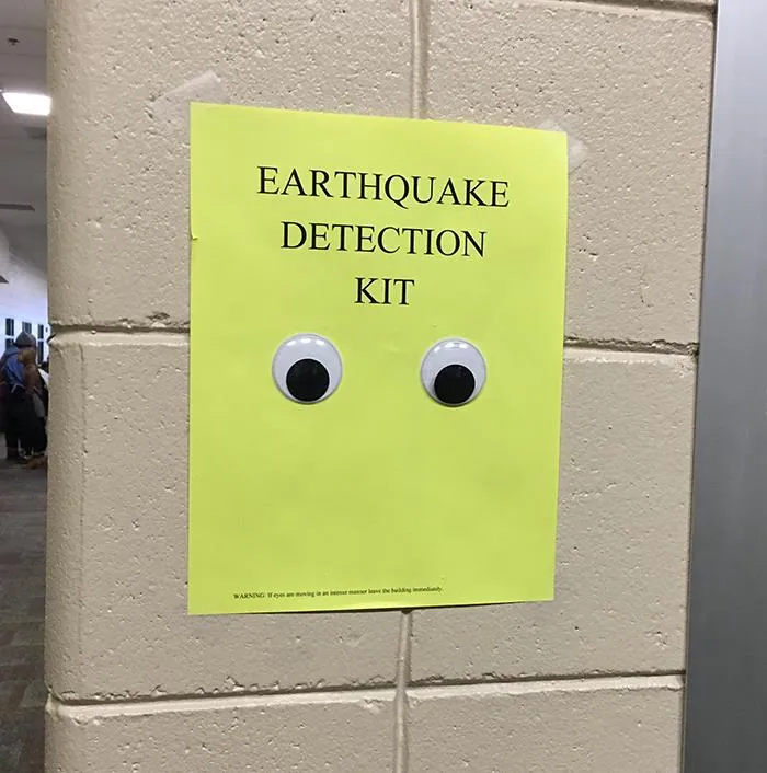 Googly eyes on an "Earthquake Detection Kit" sign on a wall from science memes collection.