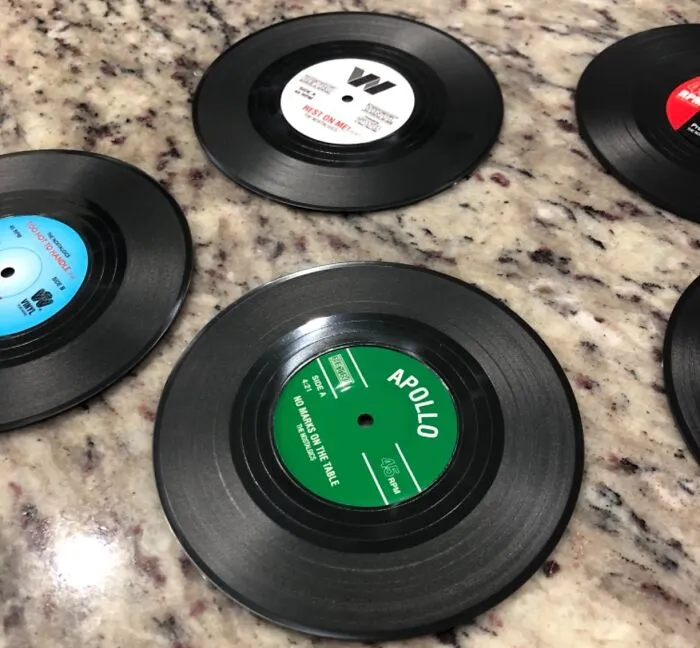 Spin Their Home Decor Into The Groove With The <a Style="Display:inline;" Href="Https://Www.amazon.com/Ankzon-Coasters-Drinks-Gift-Labels-Prevent/Dp/B07cqz9mnk?ie=utf8&linkcode=ll1&tag=bpapple-20&linkid=dce2a6de74c80c340da16f3394890814&language=en_us&ref_=as_li_ss_tl" Target="_blank"><span Style="Font: Inherit; Color: #d74b1f;"> Vinyl Coasters</Span>, A Gift That's Music To Their Ears (And Their Furniture)!