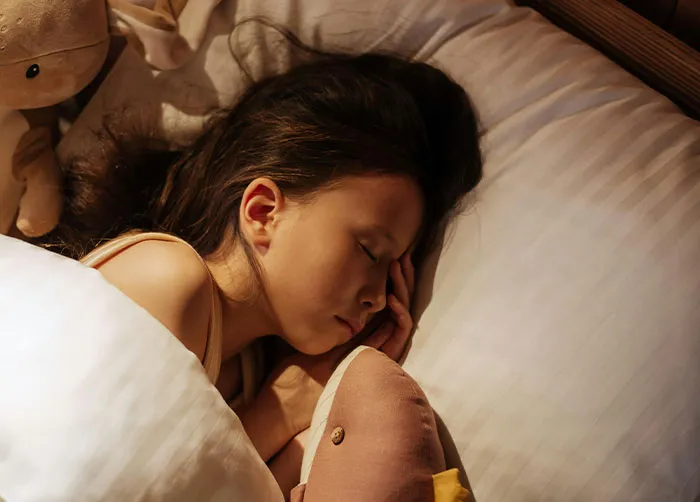 A sleeping child with toys, suggesting the peace after unsettling sentences that stopped conversations cold.