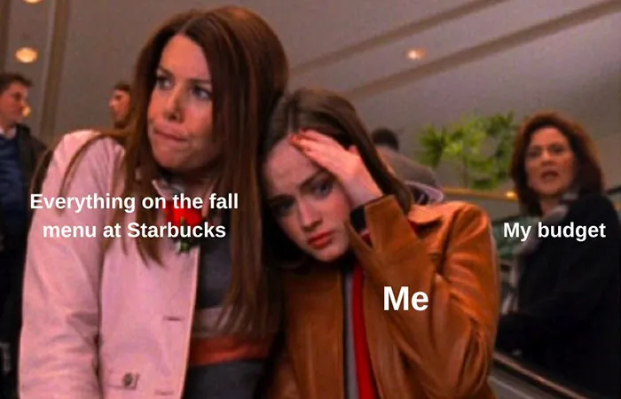 Stressed person labeled "Me" comforted by "Fall menu at Starbucks," with "My budget" in the background. Cozy season meme.