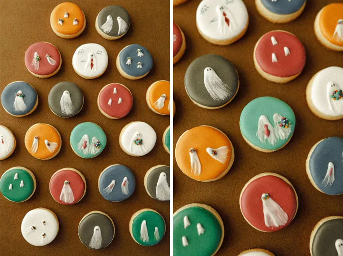 Halloween snacks featuring decorated cookies with colorful icing and ghost designs on a brown background.