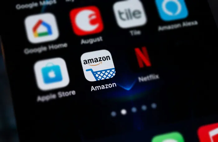 Smartphone screen displaying popular apps like Amazon and Netflix, focusing on frugal choices in everyday life.