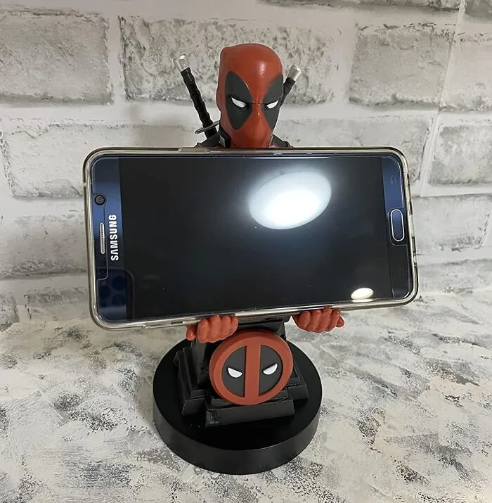 Hang Tight To Your Phone With The <a Style="Display:inline;" Href="Https://Www.amazon.com/Exquisite-Gaming-Cable-Guy-Deadpool-Controller/Dp/B07x42819l?ie=utf8&linkcode=ll1&tag=bpmelon-20&linkid=b8cfaa208856baf195400e748d0594fd&language=en_us&ref_=as_li_ss_tl" Target="_blank"><span Style="Font: Inherit; Color: #d74b1f;"> Deadpool Phone Holder</Span>