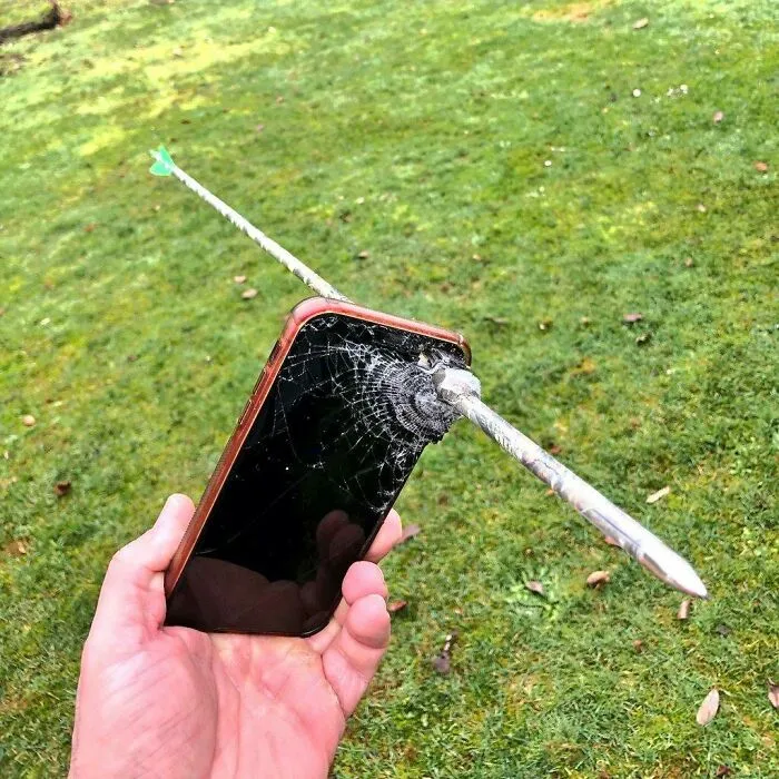 Broken smartphone with arrow piercing the screen, reflecting regretful spending.