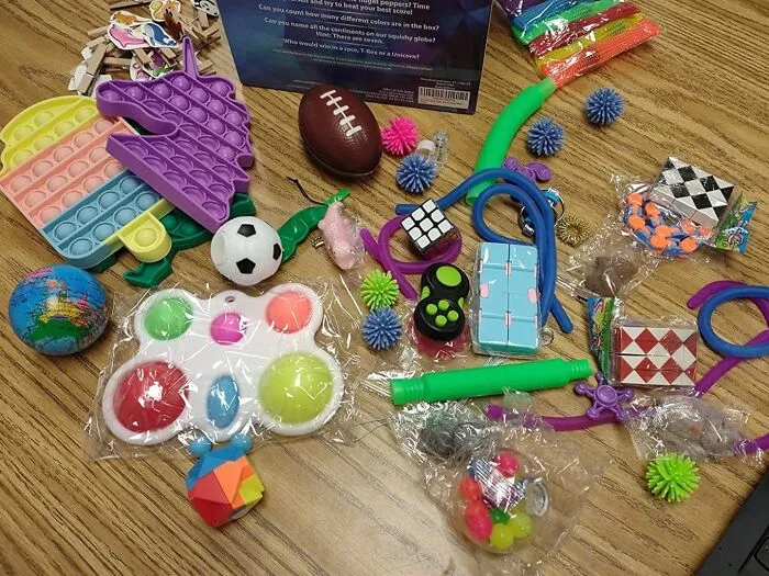 Provide A Treasure Trove Of Tactile Fun With The <a Style="Display:inline;" Href="Https://Www.amazon.com/Pcs-Fidget-Pack-Autistics-Classroom/Dp/B0973r7jmp?ie=utf8&linkcode=ll1&tag=bpkomodo-20&linkid=033dde9ed1e104773fd951b240a925a6&language=en_us&ref_=as_li_ss_tl" Target="_blank"><span Style="Font: Inherit; Color: #d74b1f;"> 50 Pcs Fidget Toys Pack</Span>, A Diverse And Interactive Collection Of Fidget Spinners, Putty, Stress Balls, And More, Perfect For Kids With Restless Hands And Minds