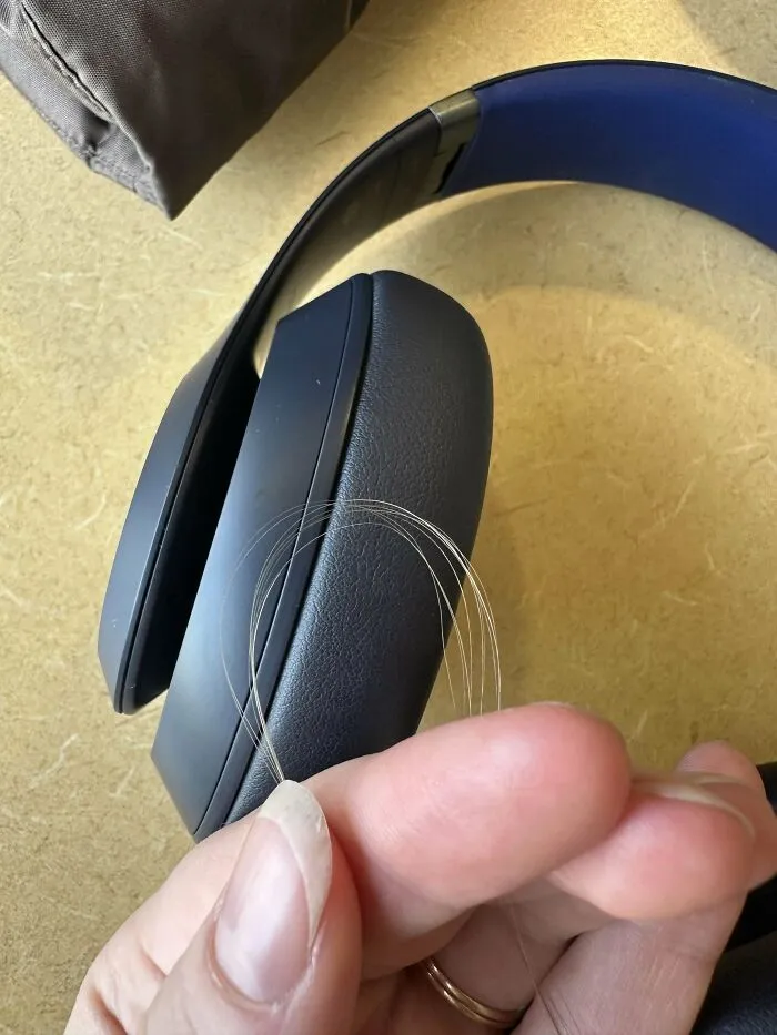 Loose hair caught in headphones, a mildly irritating discovery.