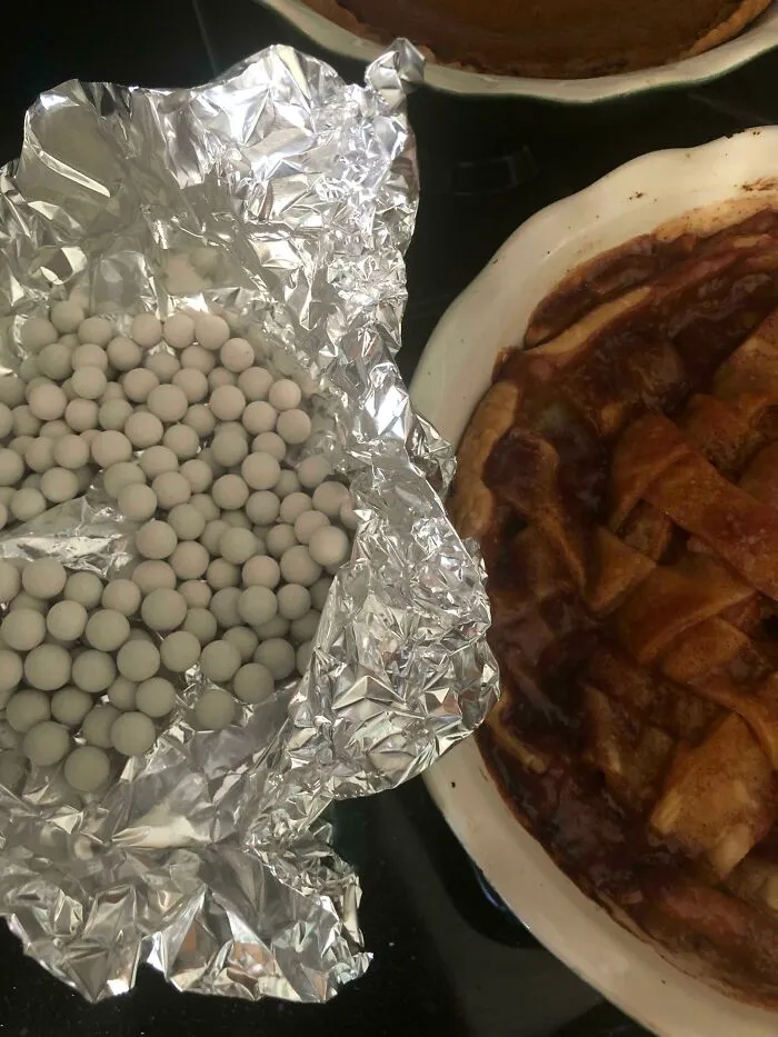 Saw These Little White Balls In Foil Next To My Wife’s Apple Pie. Thought She Made Candies, Too. Now I’m Looking For A Dentist On Thanksgiving Because I Bit Into About 3 Ceramic Pie Weights