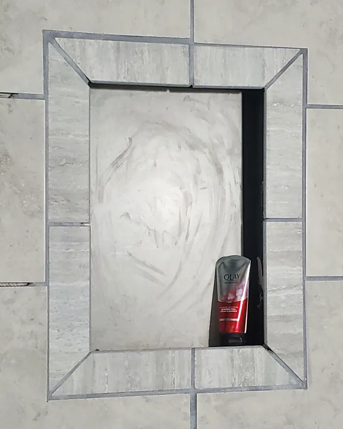 Shower niche with awkward tile alignment showcases a home improvement fail.