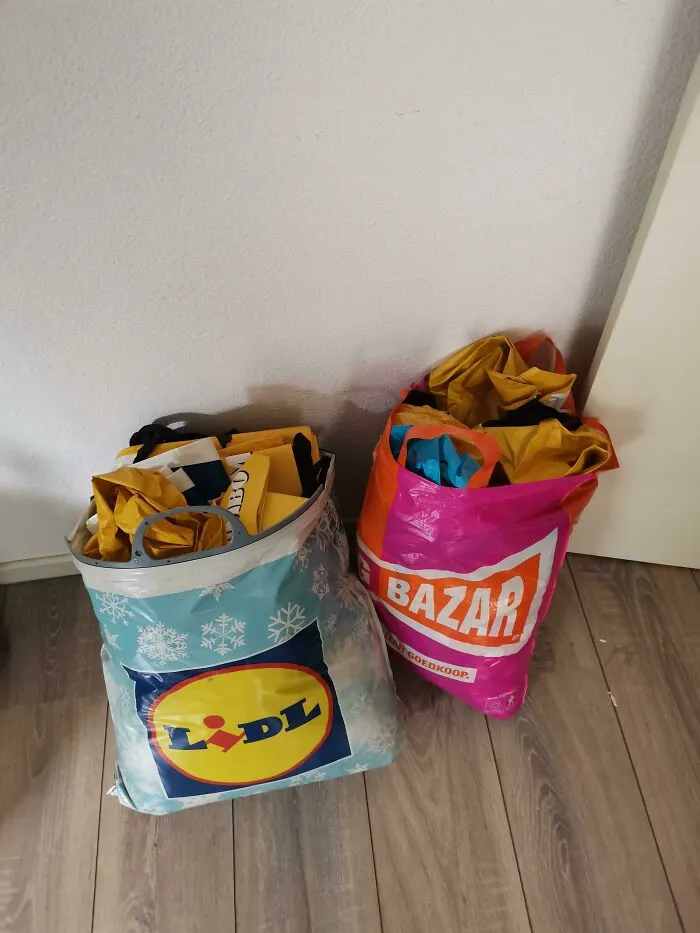 Two shopping bags filled with paper, exemplifying the concept of weaponized incompetence, placed on a wooden floor.