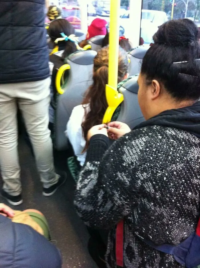 She Is Tying A Random Persons Hair To The Bus Rail