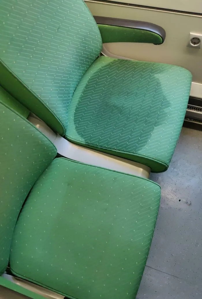 Wet public transport seat causing discomfort for passengers.