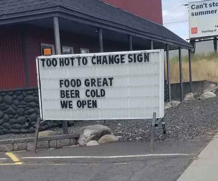 Funny ad fail on restaurant sign: "Too hot to change sign. Food great, beer cold, we open."