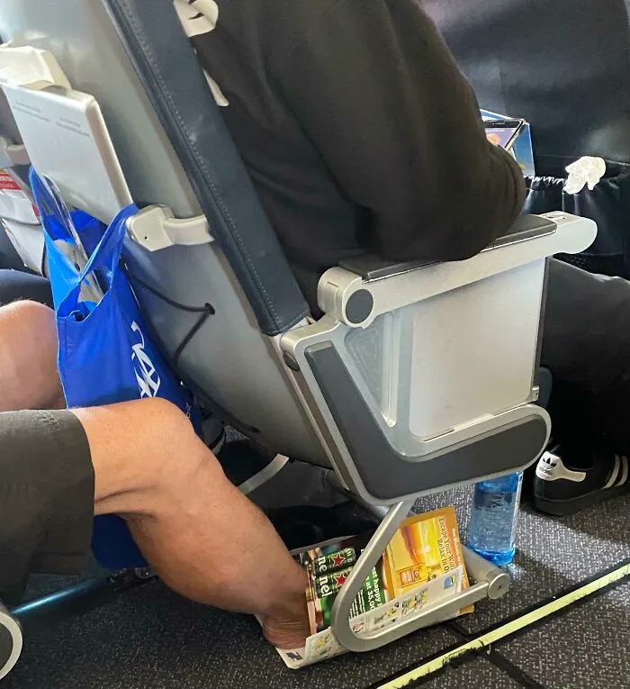 Man Uses Airplane Safety Brochure & Inflight Magazine To Protect His Naked Feet From Touching The Floor. He Put Them Back In The Seat Pocket When We Landed