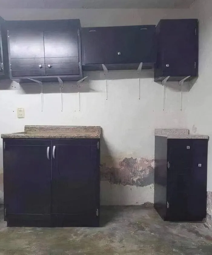 Misaligned kitchen cabinets showcasing engineering mishap.