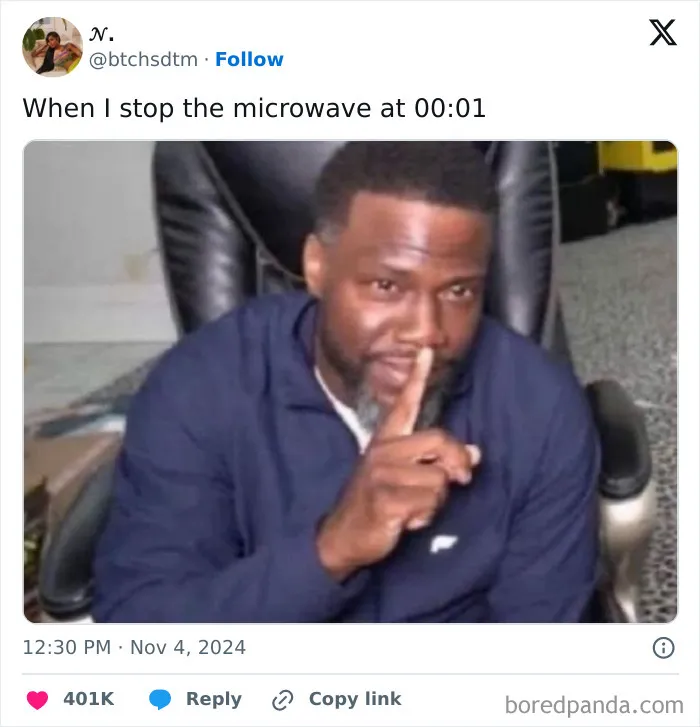 Person humorously gesturing silence in an online funny tweet, referencing stopping the microwave at 00:01.