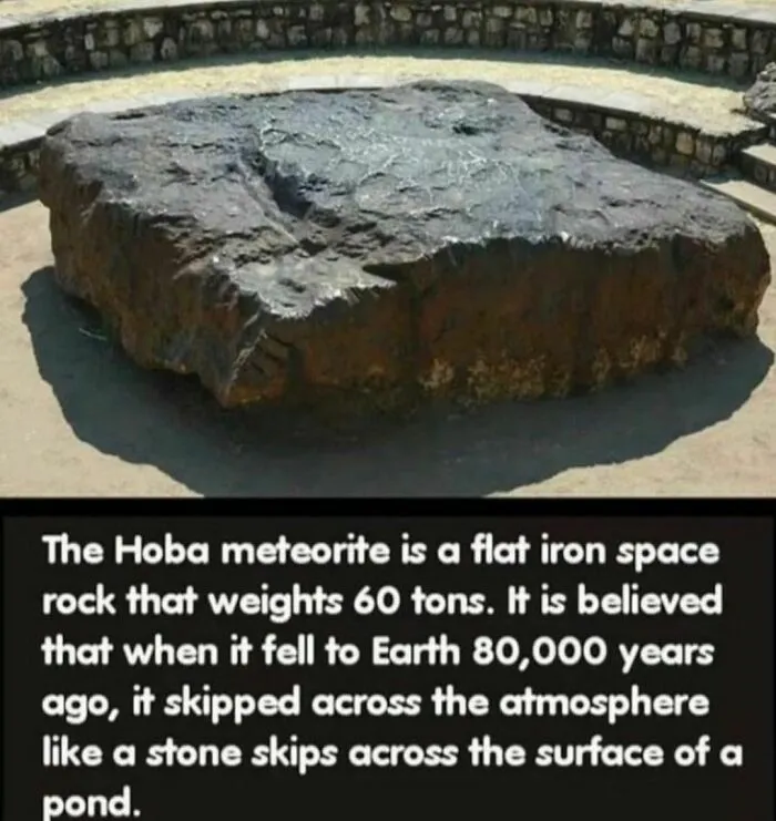 Hoba meteorite, a massive iron rock, known for its eerie history, displayed in an outdoor setting with text description.