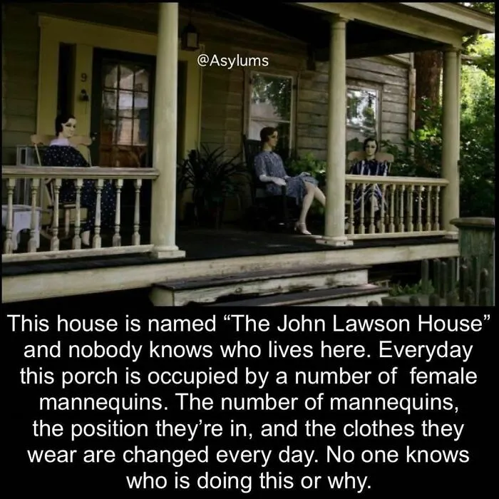 Three mannequins dressed in vintage clothing sit on the porch of a house, creating a creepy atmosphere.
