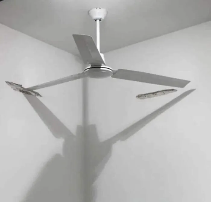 Ceiling fan blades hitting walls, illustrating an engineering mishap.