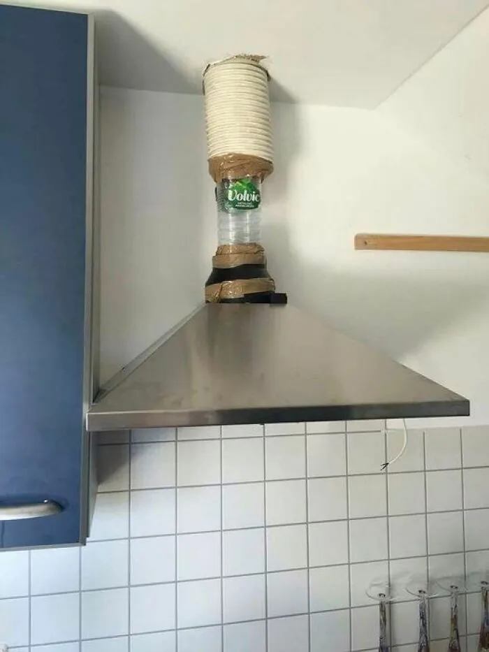 Improvised kitchen exhaust made with a plastic bottle, showcasing a quirky engineering solution.