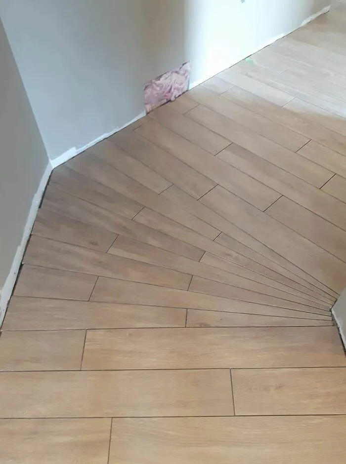 Poorly aligned wood floor tiles showcase a common engineering mistake.