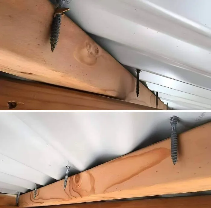 Screws improperly installed in a wooden plank, illustrating engineering mistakes.