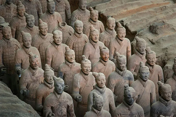 Terracotta Army statues, a hyped travel destination, viewed from above in their excavation pit.