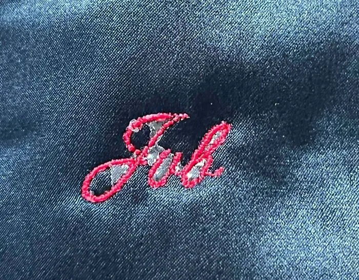 Embroidery with "Jul" in red thread, a classic disappointing present.