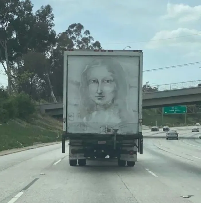 Somebody Drew A Mona Lisa With Dust Accumulated On The Truck Box