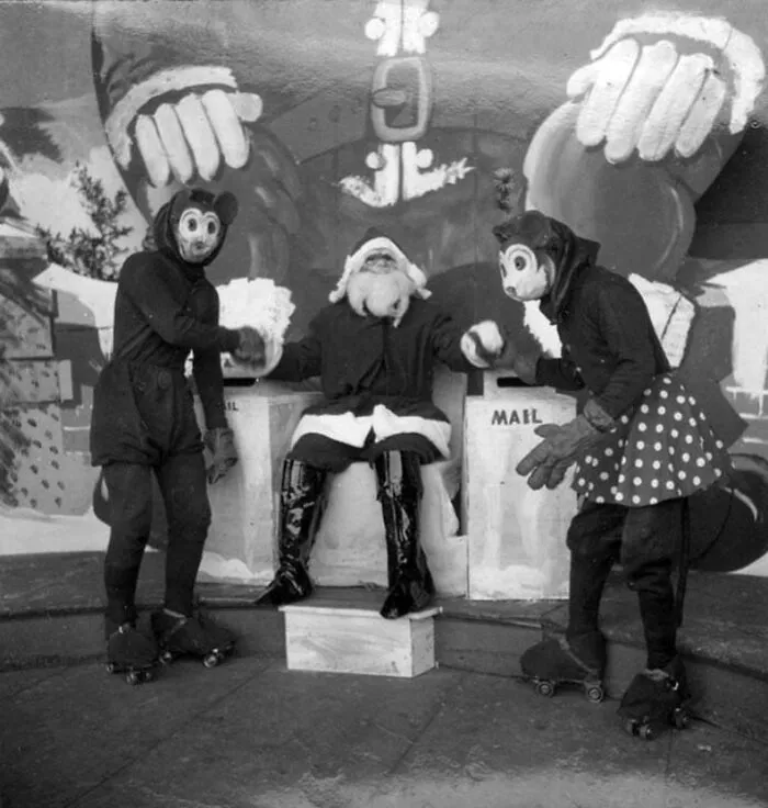 Santa Shaking Hands With Mickey And Minnie Mouse On Roller Skates