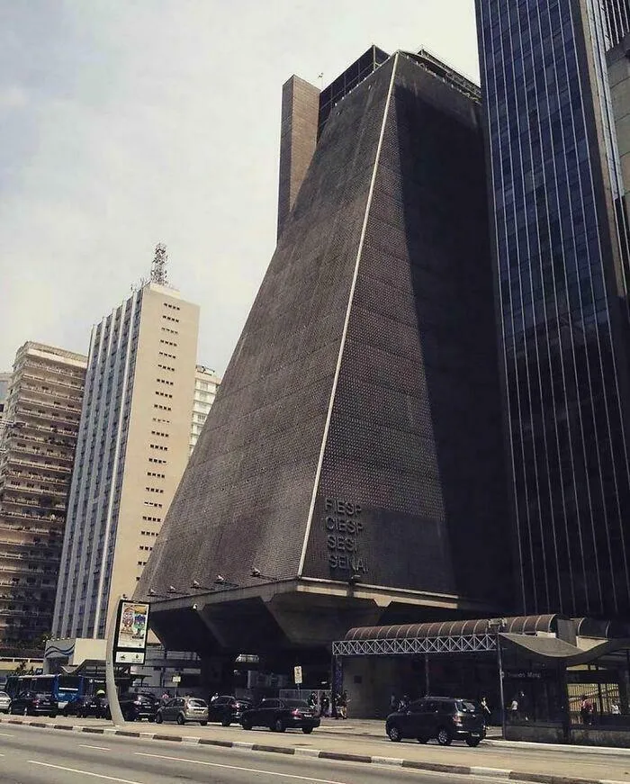 Dark, imposing building with sharp angles and textured facade, exuding an evil aura like a supervillain headquarters in a cityscape.