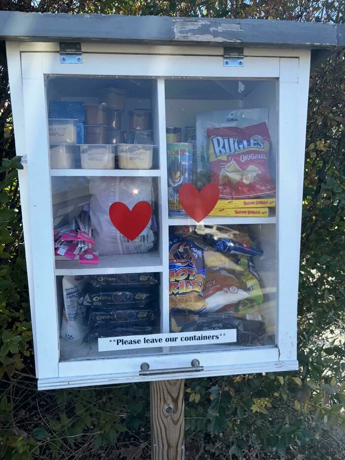 A small pantry containing snacks and food items, including chips and pudding, discovered while dumpster diving.