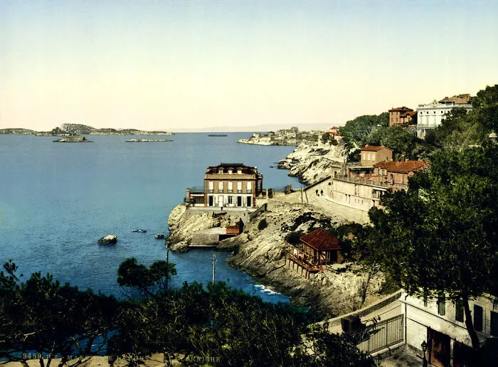 Historic coastal landscape in color showing how the world appeared 100 years ago, with cliffs and buildings by the sea.
