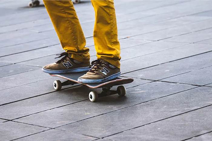 Adult in yellow pants skateboarding, fulfilling childhood denied dreams.