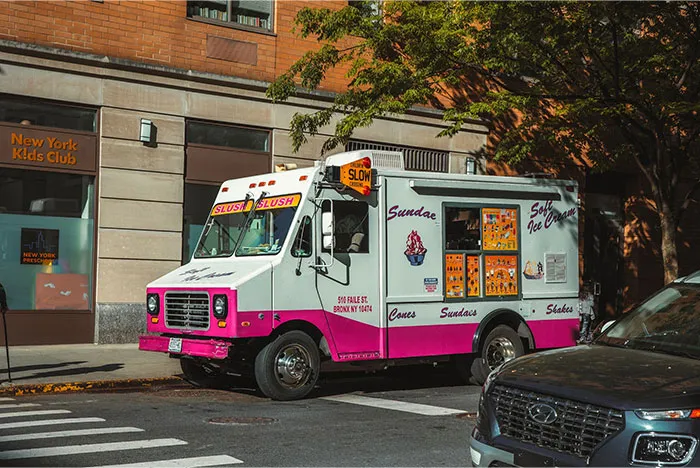 Ice cream truck parked on a city street, representing things bought by adults denied childhood treats.