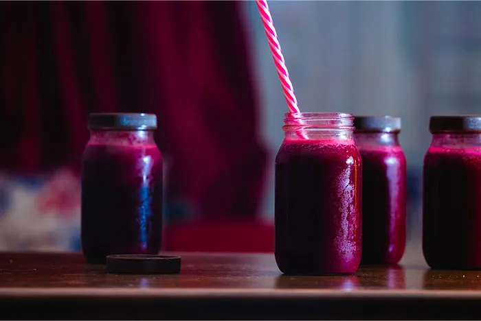 Jars of purple juice with a straw, illustrating a crazy body life hack idea.