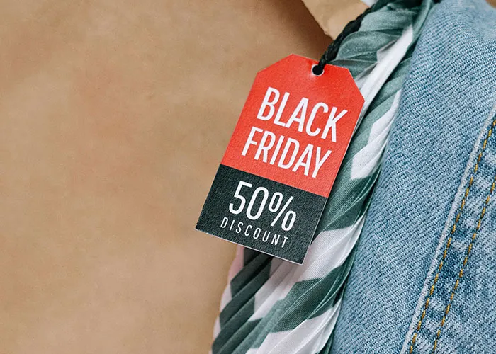 Black Friday 50% discount tag on denim, showcasing creative frugal hacks for cash savings.