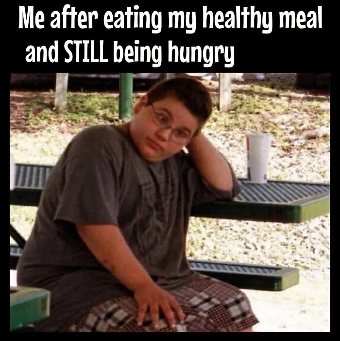 A boy looking frustrated after eating a healthy meal, capturing dieting frustrations with a humorous touch.