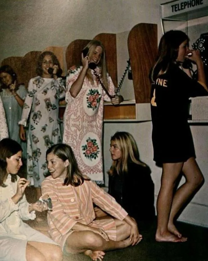 Girls Waiting In Line To Use The Telephone In Their Dormitory