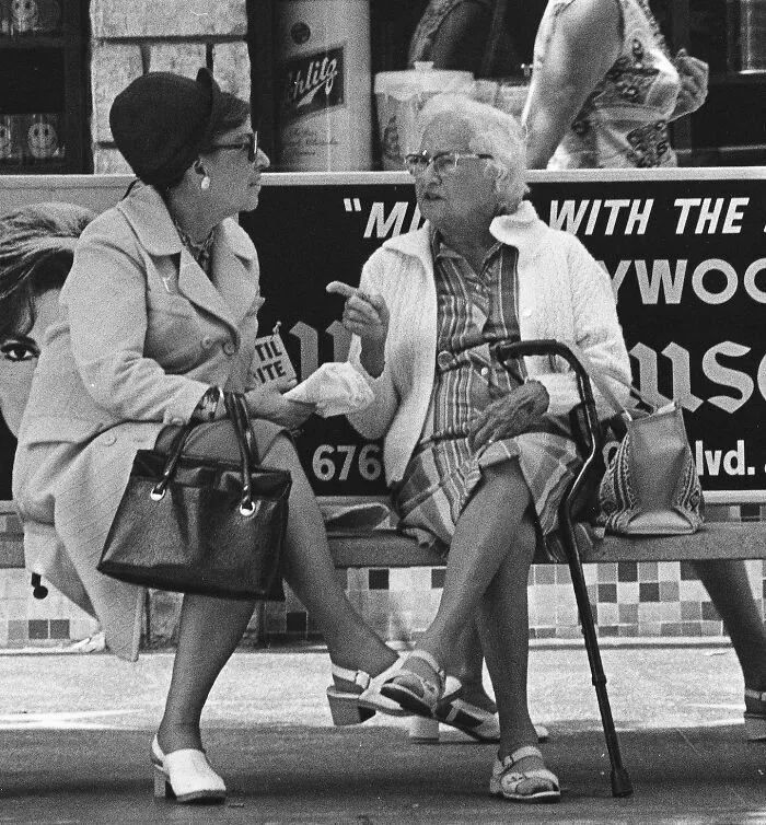 Women Sitting At A Bus Stop On Hollywood Boulevard