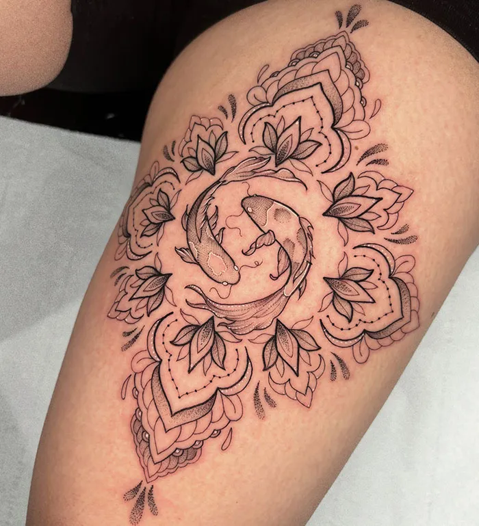Intricate mandala tattoo with koi fish design on thigh, showcasing detailed artistry and symbolizing harmony.