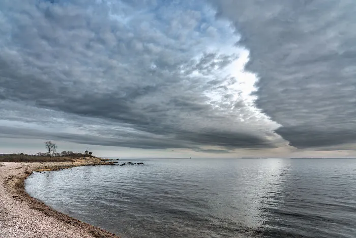 Spectacular coastal view with dramatic clouds over the ocean, highlighting amazing views in various states.