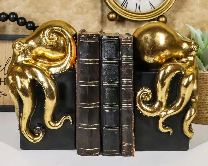 Slay Your Book Game With The <a Style="Display:inline;" Href="Https://Www.amazon.com/Dp/B084h3ljkd?asc_item-ID=amzn1.ideas.2gtou1vub2j3t&th=1&linkcode=ll1&tag=bpfig-20&linkid=cc37a163982f19a0c114b72c0b985ef2&language=en_us&ref_=as_li_ss_tl" Target="_blank"><span Style="Font: Inherit; Color: #d74b1f;"> Golden Octopus Bookend </Span>. This Cephalopod Cutie Keeps Your Books In Line In The Best Possible Way