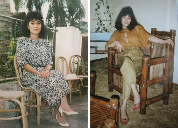 Two women showcasing 80s fashion trends, one in a patterned dress and heels, the other in a blouse and pants, seated in wicker chairs.