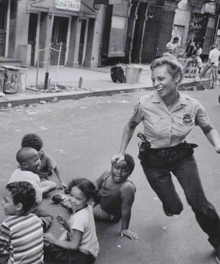 A Police Officer Playing Duck Duck Goose With Children In New York, 1970