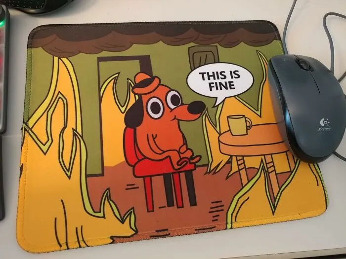 Embody The Spirit Of Resigned Acceptance With This <a Style="Display:inline;" Href="Https://Www.amazon.com/Gaming-Mousepad-Computer-Portable-Mousepads/Dp/B09t93813k?ie=utf8&th=1&linkcode=ll1&tag=bphawk-20&linkid=382647e2032a0d15511074129b9f7850&language=en_us&ref_=as_li_ss_tl" Target="_blank"><span Style="Font: Inherit; Color: #d74b1f;"> "This Is Fine" Meme Mousepad </Span>, A Hilarious And Relatable Addition To Your Workspace